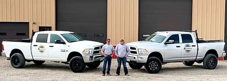 Kuboske team standing in front of their trucks